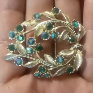 Vintage star stamped flower broach with blue and green opalescence rhinestones.